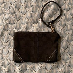 Black wristlet with leather trim.